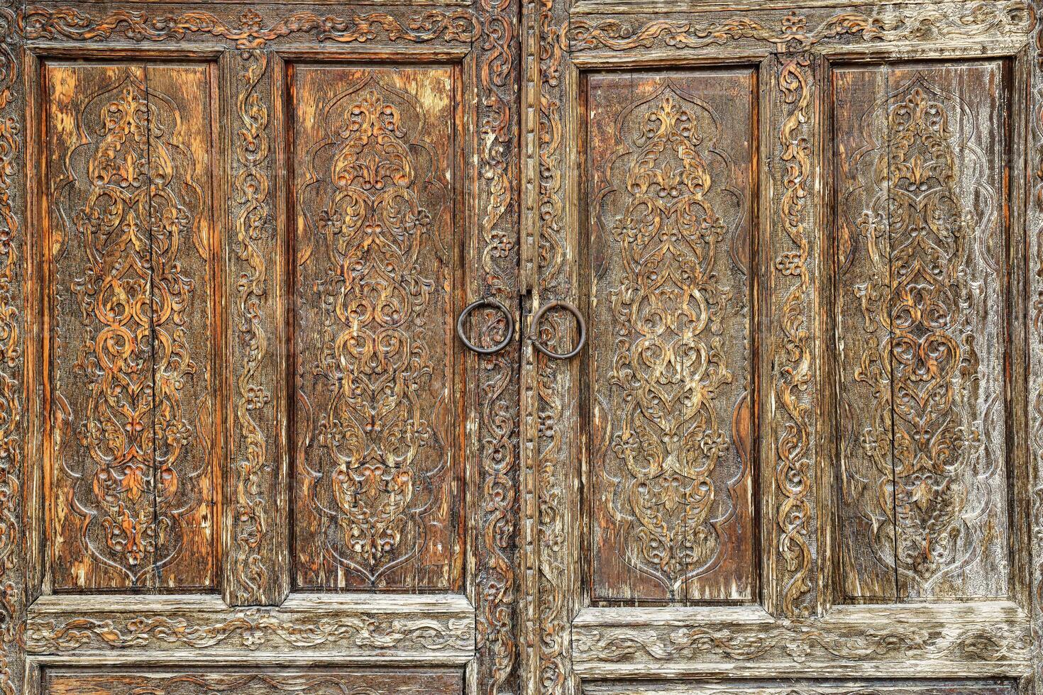 Carved wooden doors with patterns and mosaics. Abstract background for design. photo