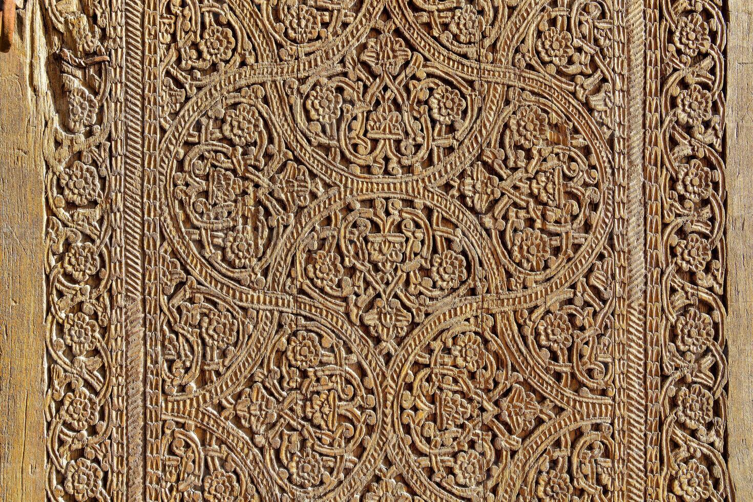 Fragment of an ancient carved wooden door. Ornate. photo