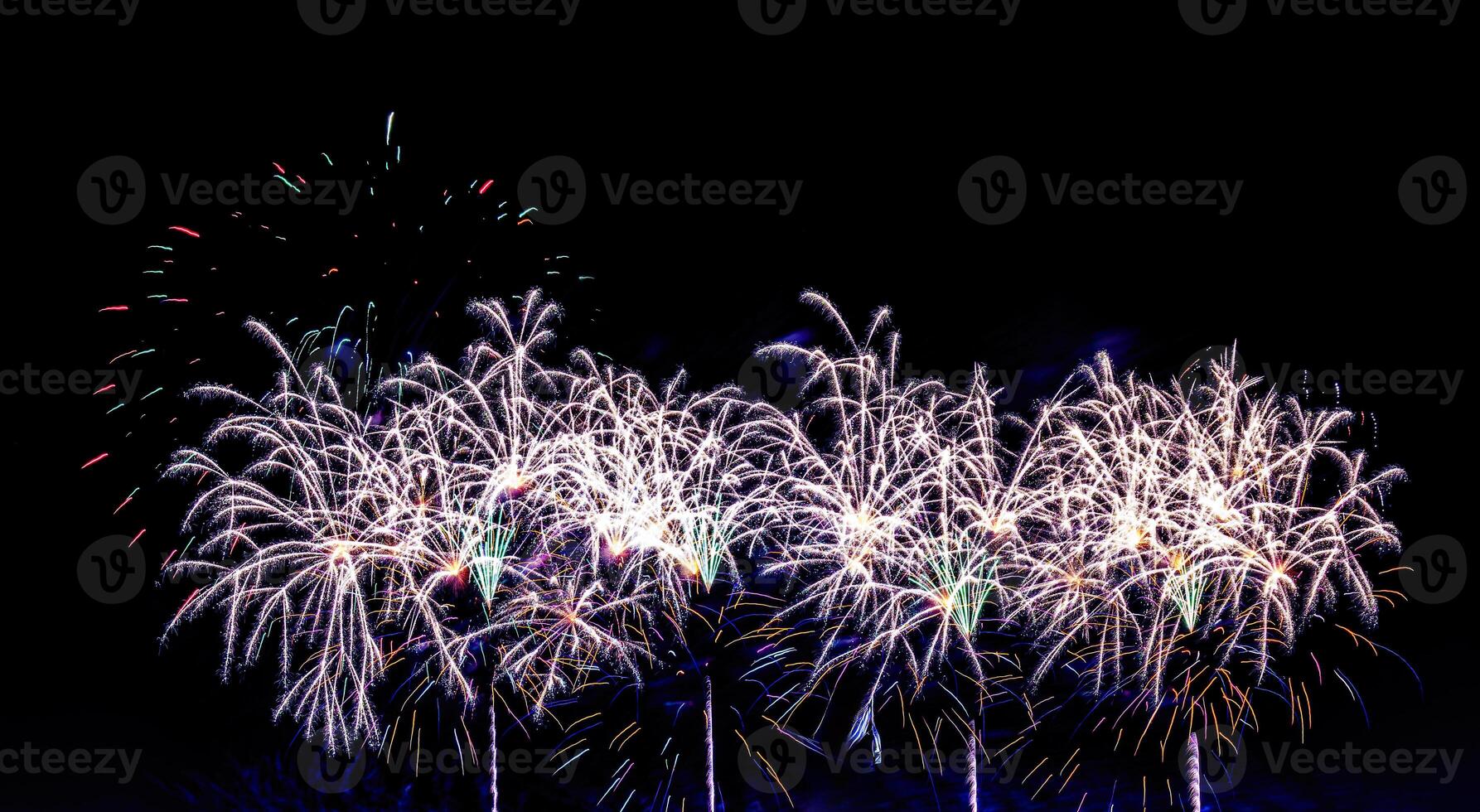 Colorful celebration fireworks isolated on a black sky background. photo