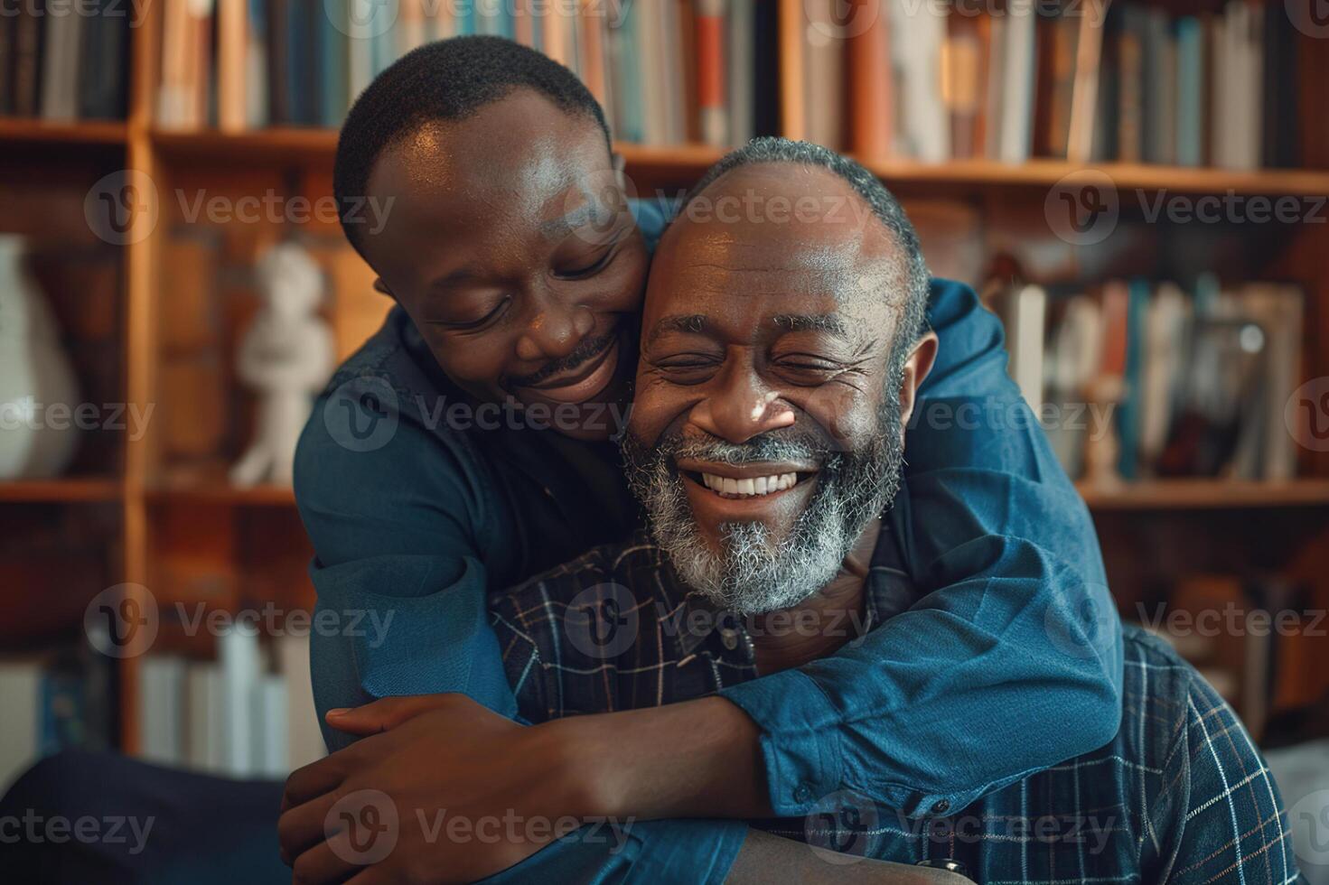 Smiling african american son hugging elderly father with beard. Two generations of men enjoy meeting on Father's Day. photo