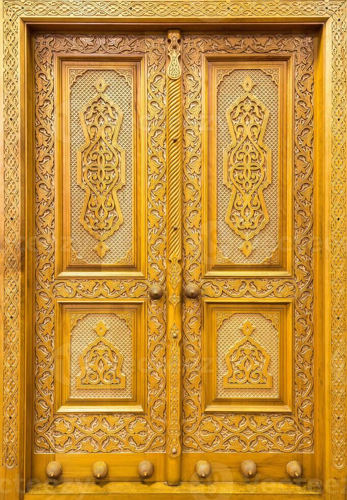 Carved wooden doors with patterns and mosaics. Abstract background. photo