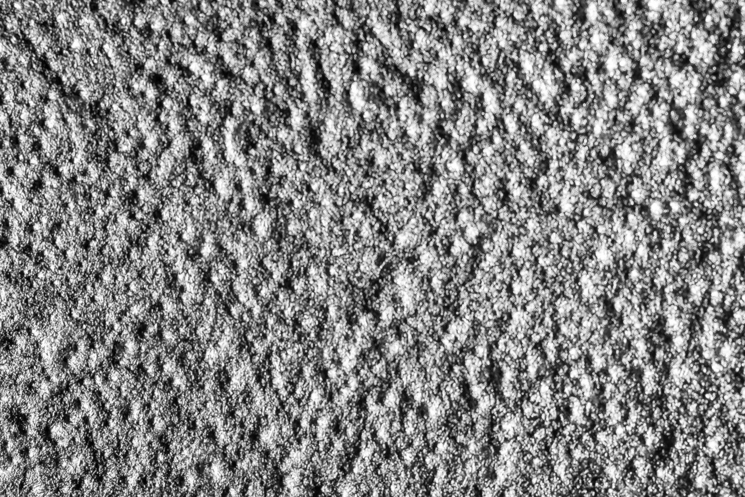 Monochrome texture of shiny grained metal. Abstract background. photo