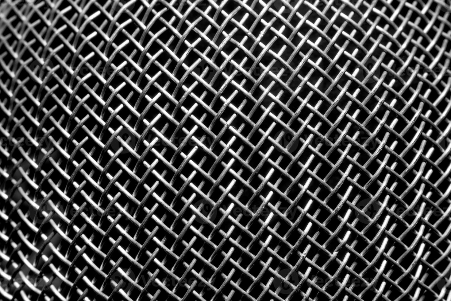 Monochrome texture of a shiny metal colander or grate. Abstract background. photo