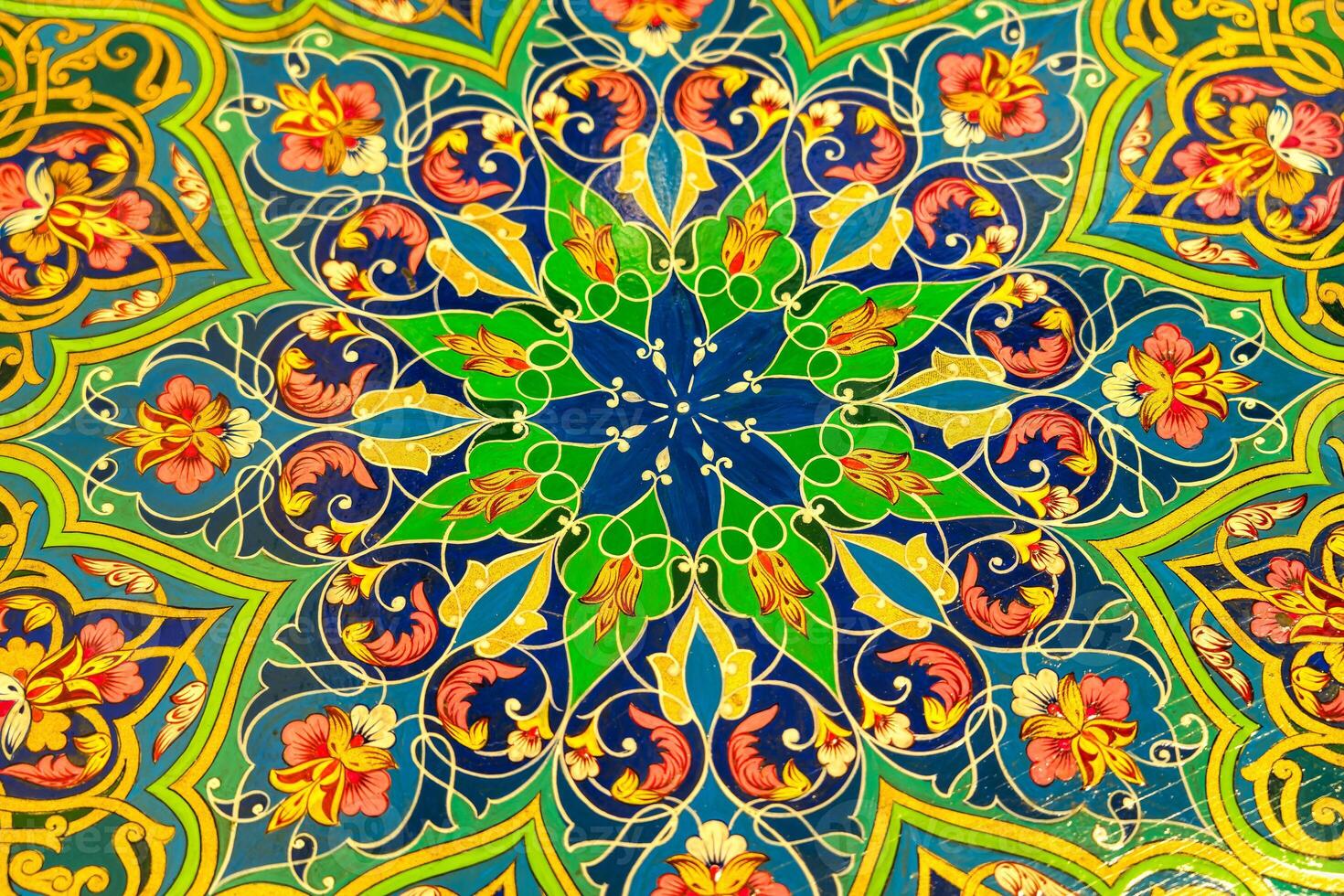 Colorful vintage oriental ornament painted on the tabletop. Abstract background. photo