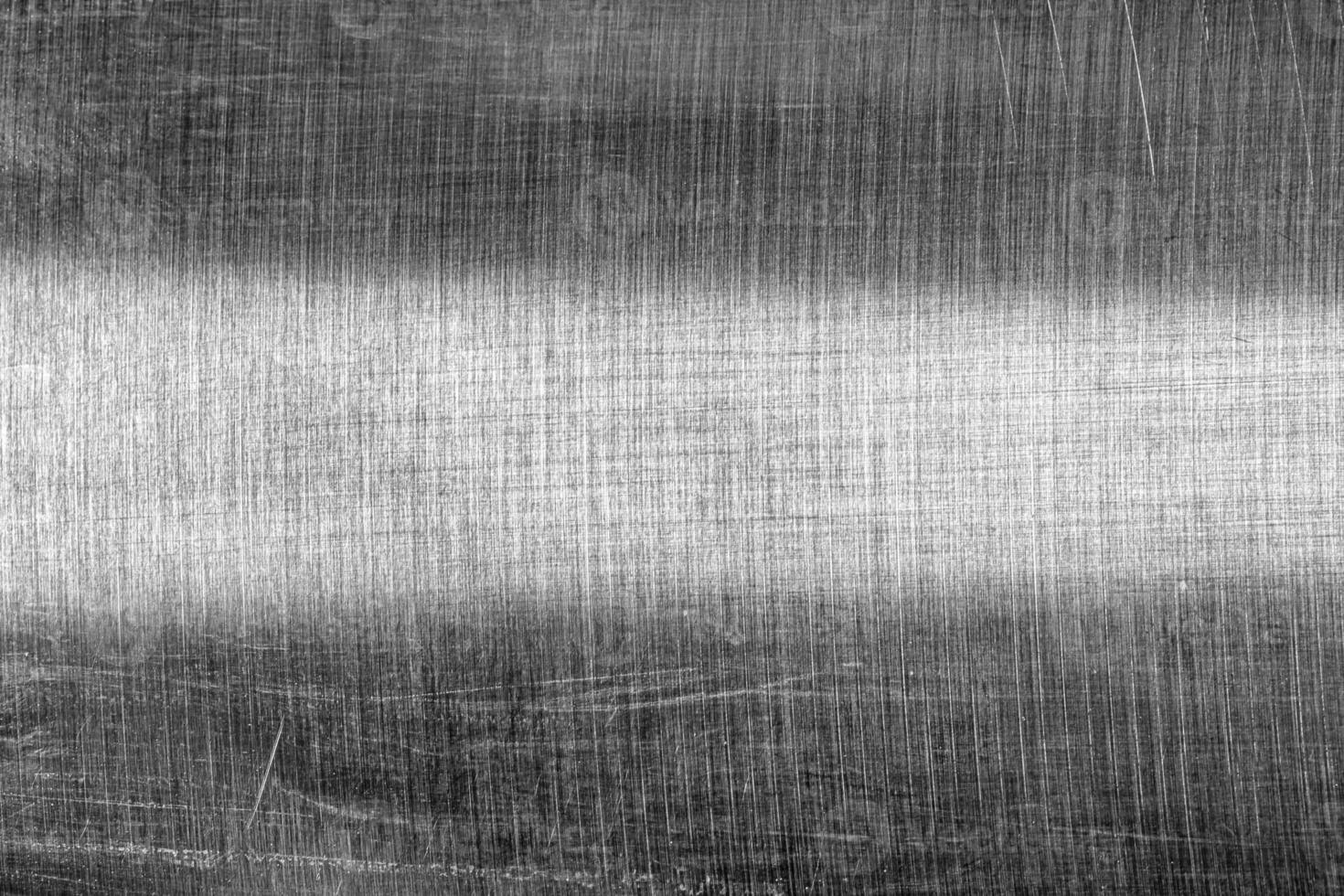 Monochrome texture of shiny scratched metal. Abstract background. photo