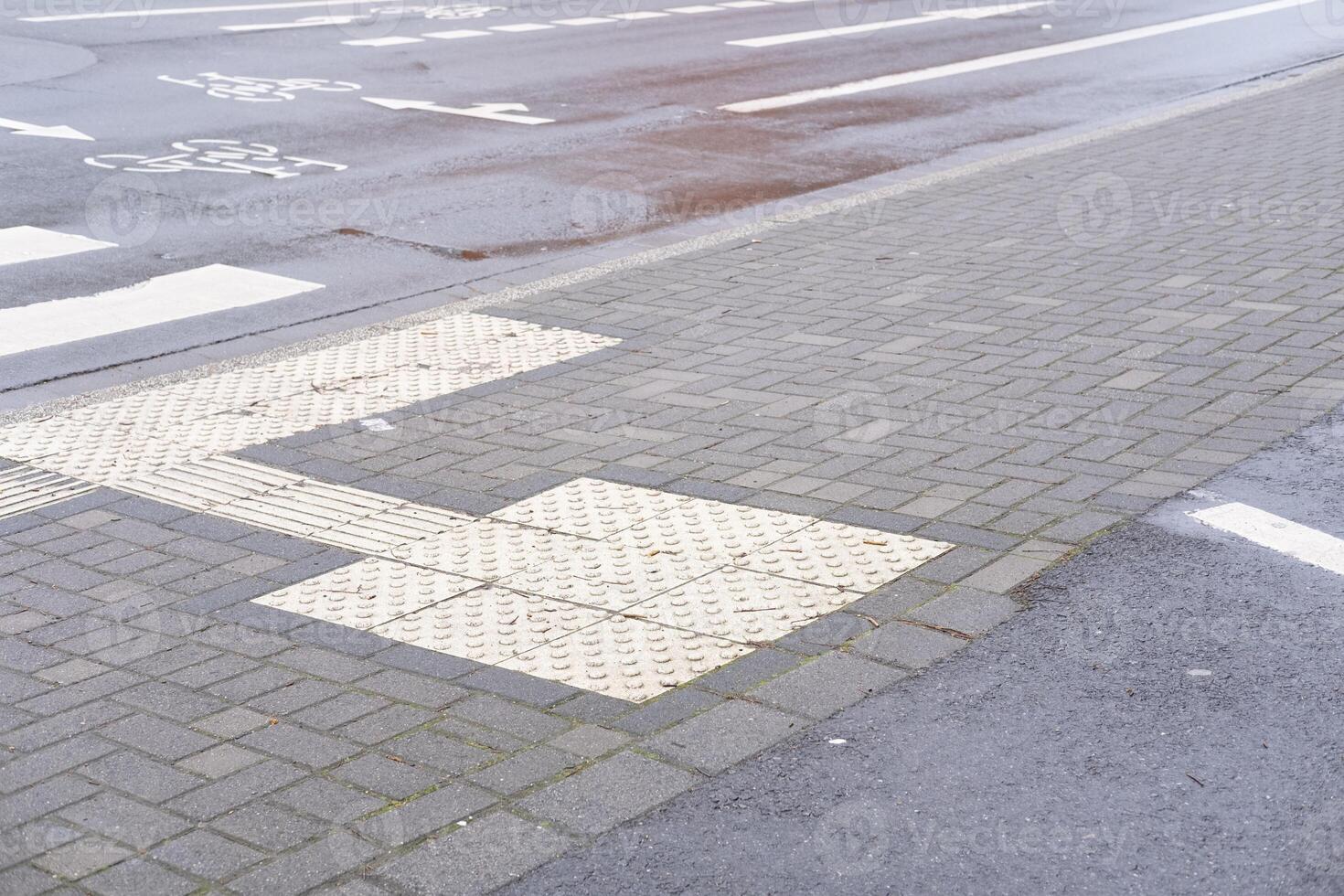 wet road with cycle path sign photo