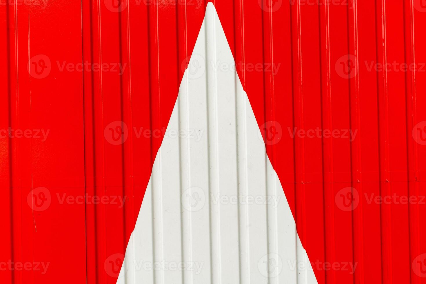 Metal wall, white arrow on red background photo