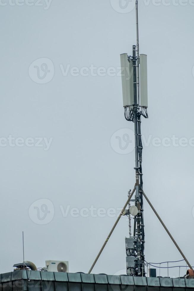 large mobile radio antennas on an office roof photo