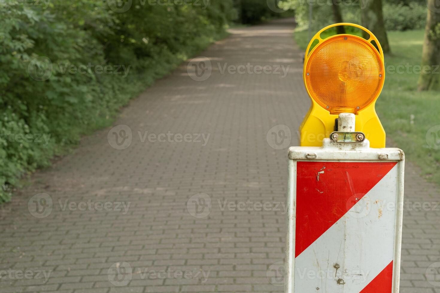 Construction site, white red barrier with warning light photo