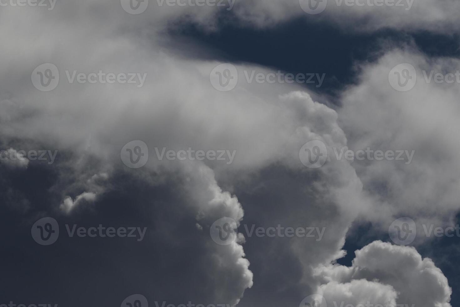Cloudscape scenery, overcast weather above dark blue sky. Storm clouds floating in a rainy dull day with natural light. White and grey scenic environment background. Nature view. photo