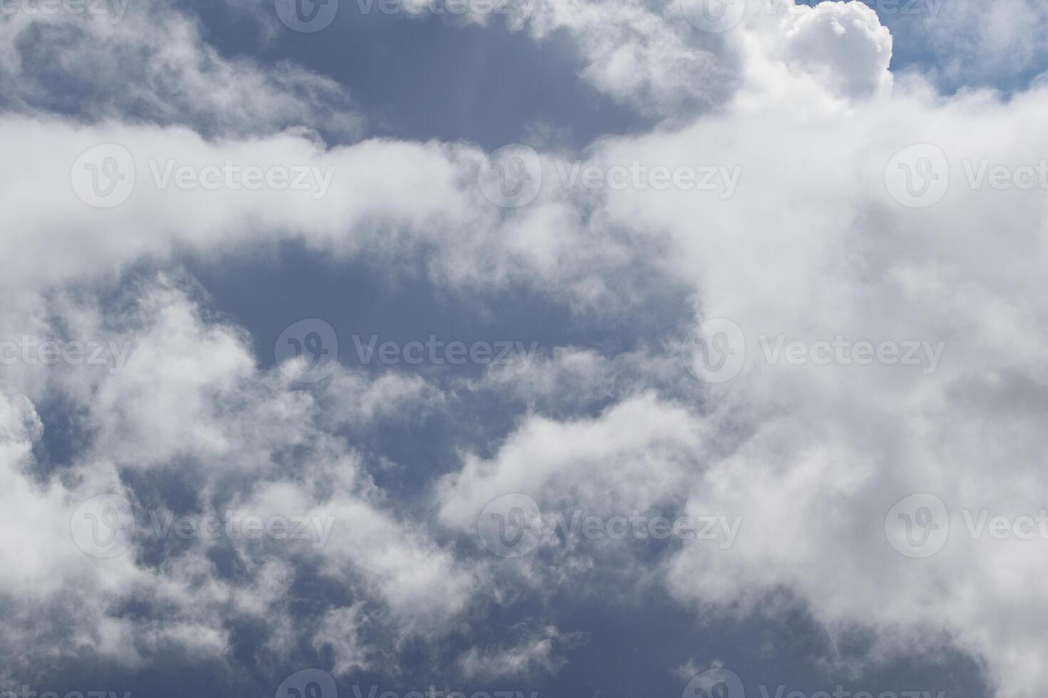 Cloudscape scenery, overcast weather above dark blue sky. Storm clouds floating in a rainy dull day with natural light. White and grey scenic environment background. Nature view. photo