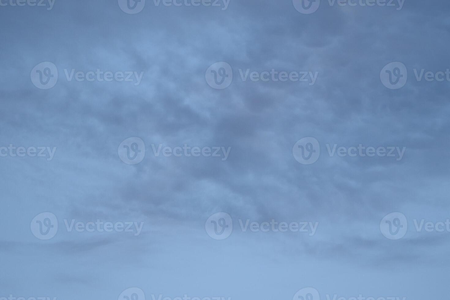 Cloudscape scenery, overcast weather above dark blue sky. Storm clouds floating in a rainy dull day with natural light. White and grey scenic environment background. Nature view. photo