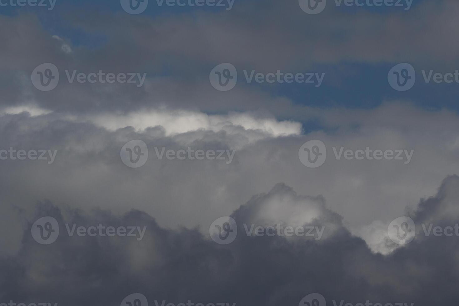 Cloudscape scenery, overcast weather above dark blue sky. Storm clouds floating in a rainy dull day with natural light. White and grey scenic environment background. Nature view. photo
