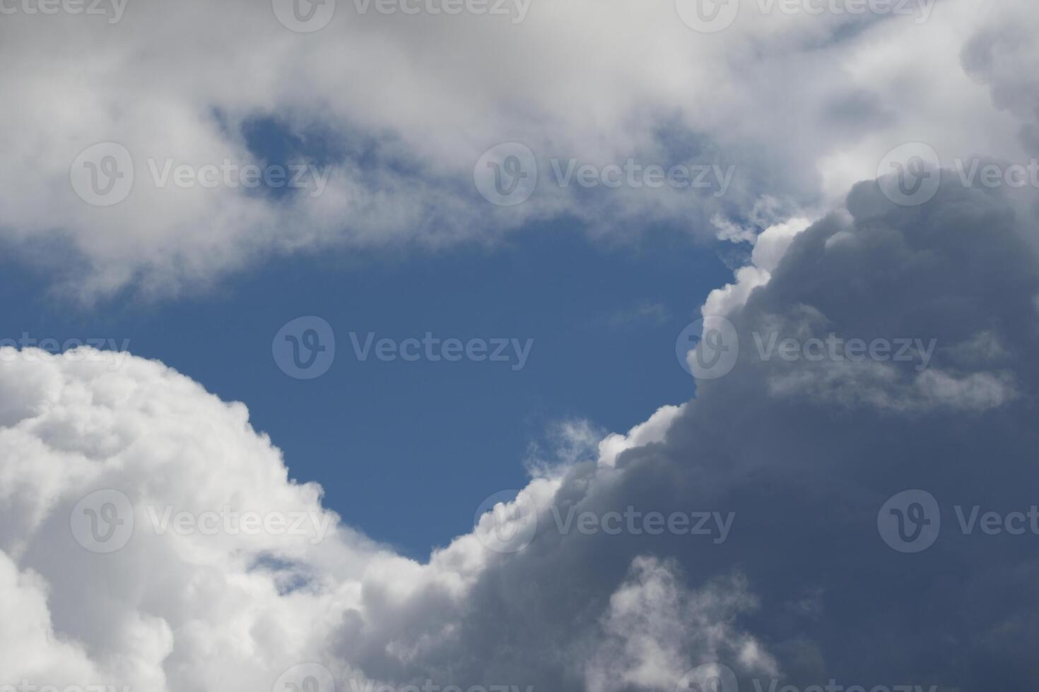 Cloudscape scenery, overcast weather above dark blue sky. Storm clouds floating in a rainy dull day with natural light. White and grey scenic environment background. Nature view. photo