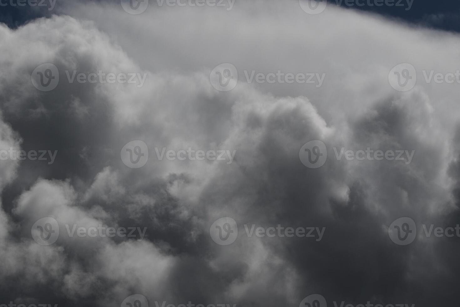 Cloudscape scenery, overcast weather above dark blue sky. Storm clouds floating in a rainy dull day with natural light. White and grey scenic environment background. Nature view. photo