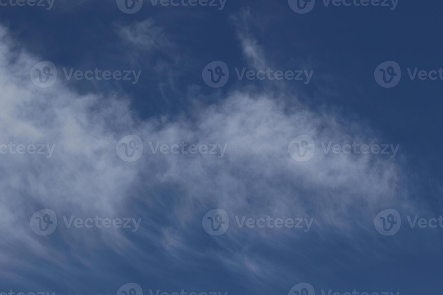 Cloudscape scenery, overcast weather above dark blue sky. Storm clouds floating in a rainy dull day with natural light. White and grey scenic environment background. Nature view. photo