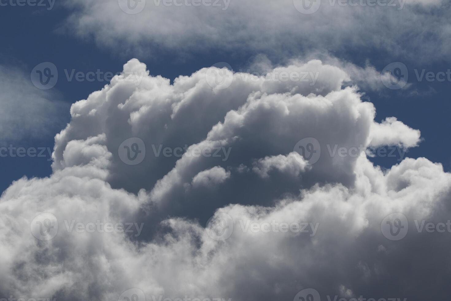 Cloudscape scenery, overcast weather above dark blue sky. Storm clouds floating in a rainy dull day with natural light. White and grey scenic environment background. Nature view. photo