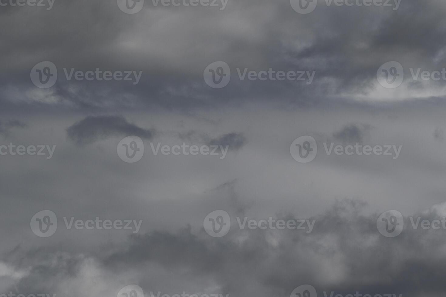 Cloudscape scenery, overcast weather above dark blue sky. Storm clouds floating in a rainy dull day with natural light. White and grey scenic environment background. Nature view. photo