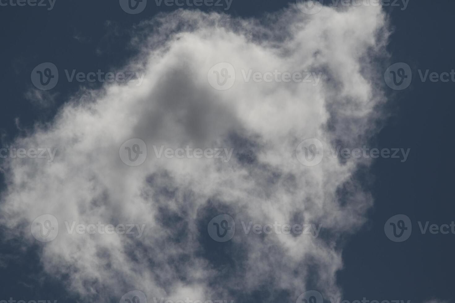 Cloudscape scenery, overcast weather above dark blue sky. Storm clouds floating in a rainy dull day with natural light. White and grey scenic environment background. Nature view. photo