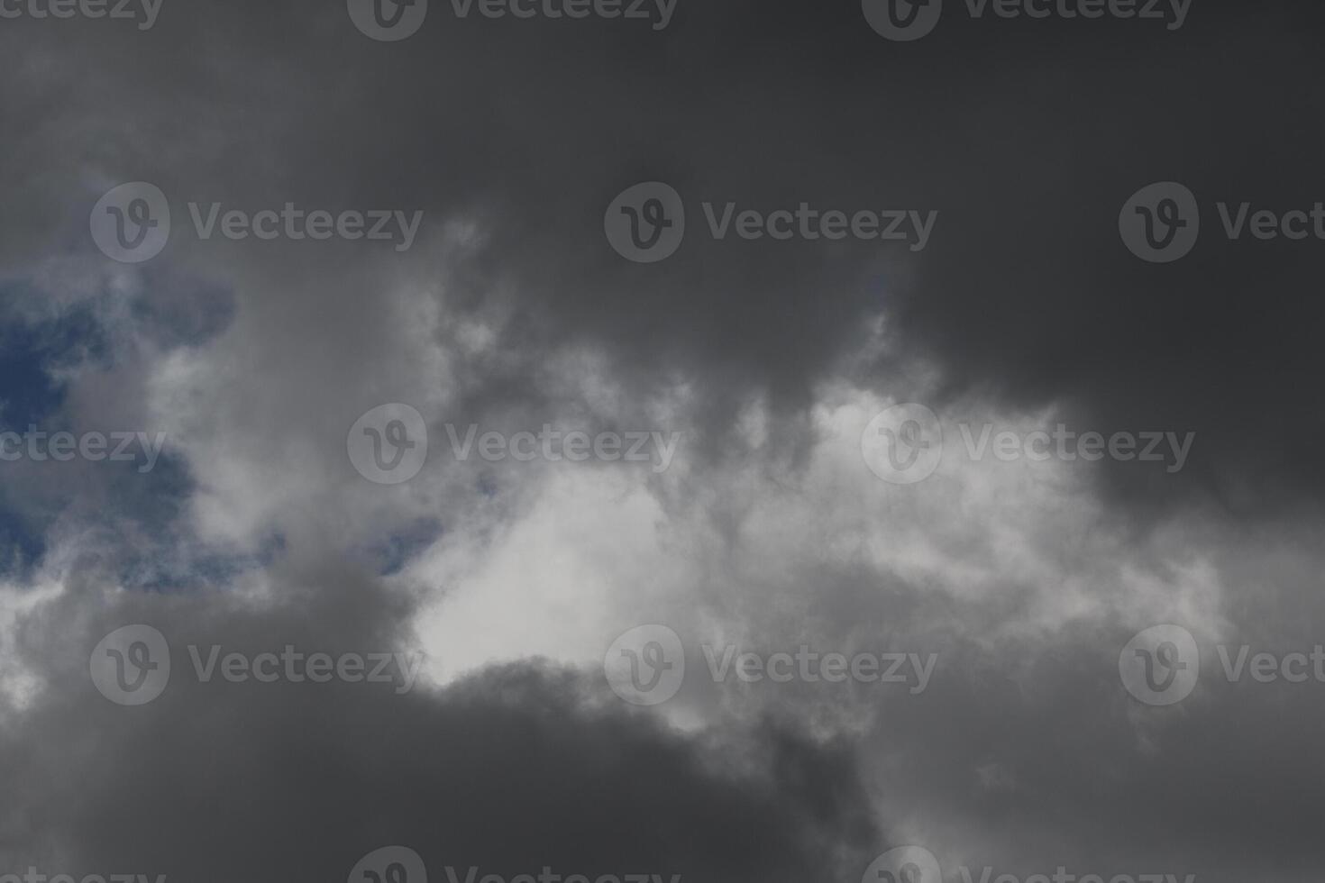 Cloudscape scenery, overcast weather above dark blue sky. Storm clouds floating in a rainy dull day with natural light. White and grey scenic environment background. Nature view. photo