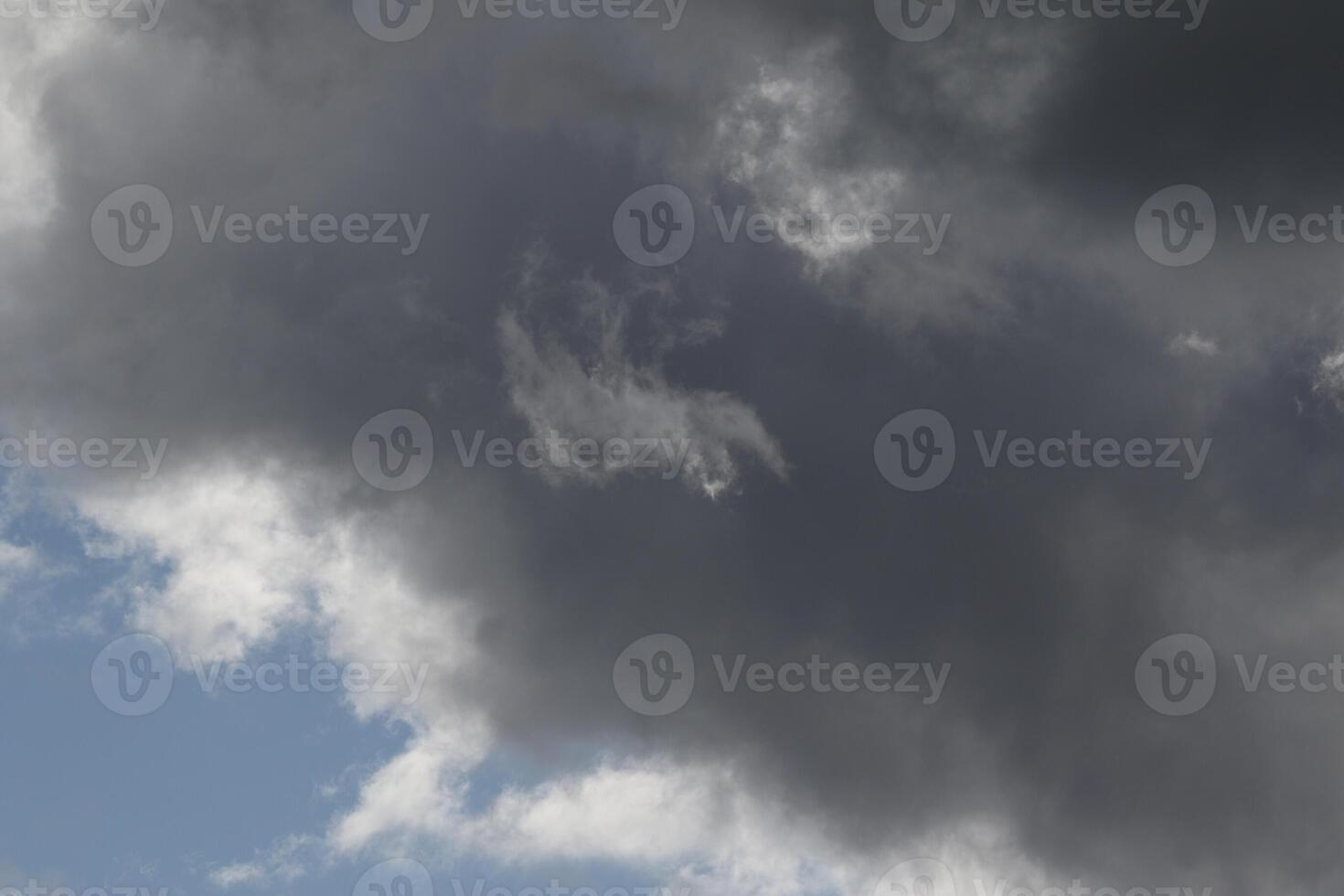 Cloudscape scenery, overcast weather above dark blue sky. Storm clouds floating in a rainy dull day with natural light. White and grey scenic environment background. Nature view. photo