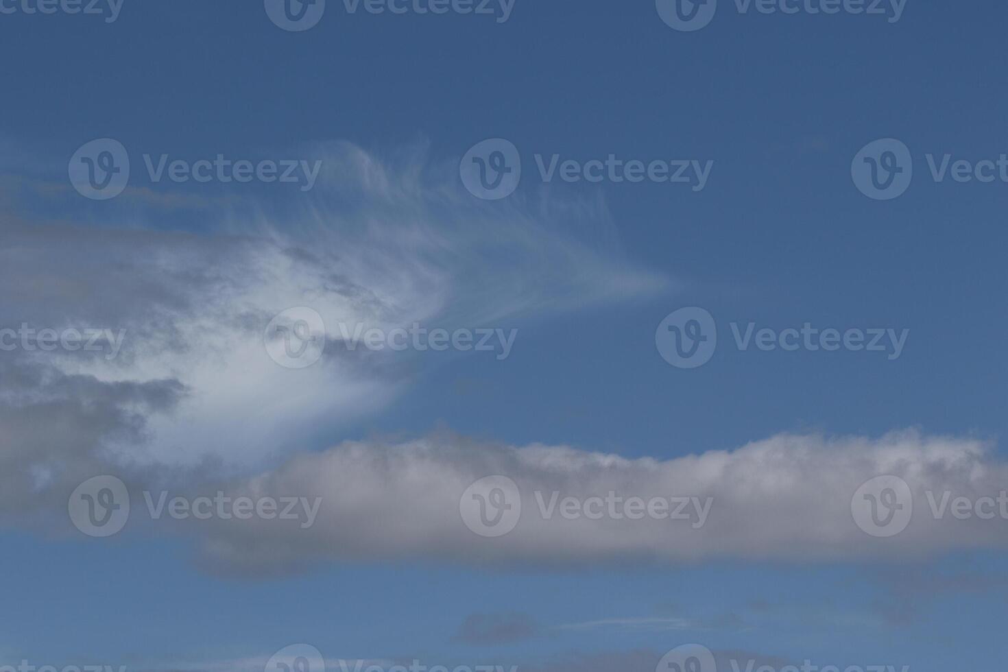 Cloudscape scenery, overcast weather above dark blue sky. Storm clouds floating in a rainy dull day with natural light. White and grey scenic environment background. Nature view. photo