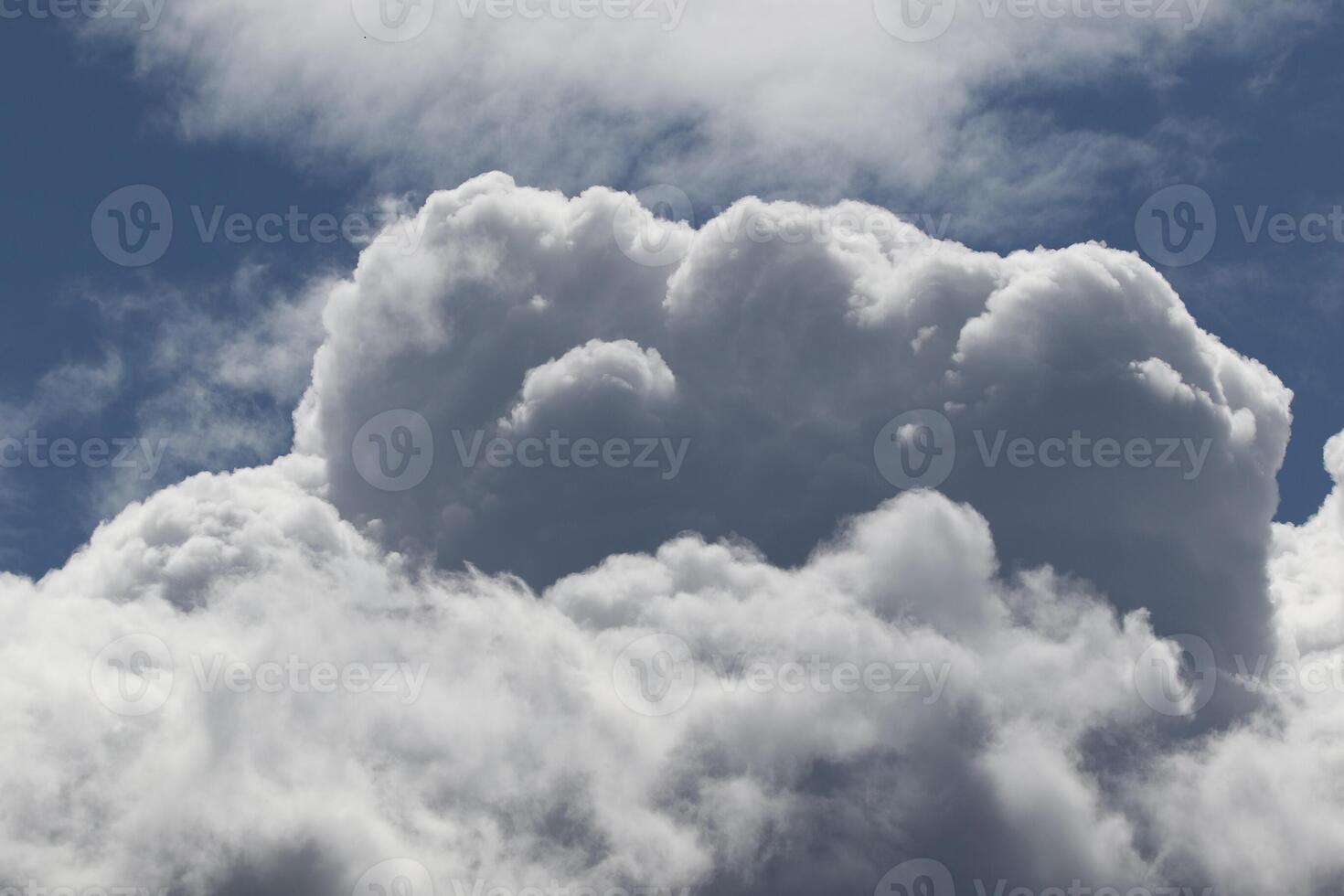 Cloudscape scenery, overcast weather above dark blue sky. Storm clouds floating in a rainy dull day with natural light. White and grey scenic environment background. Nature view. photo