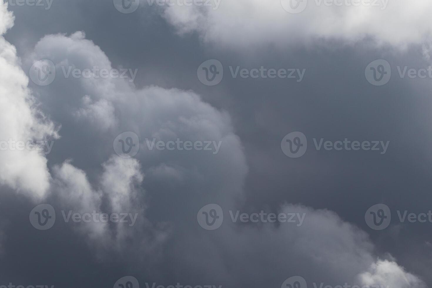Cloudscape scenery, overcast weather above dark blue sky. Storm clouds floating in a rainy dull day with natural light. White and grey scenic environment background. Nature view. photo