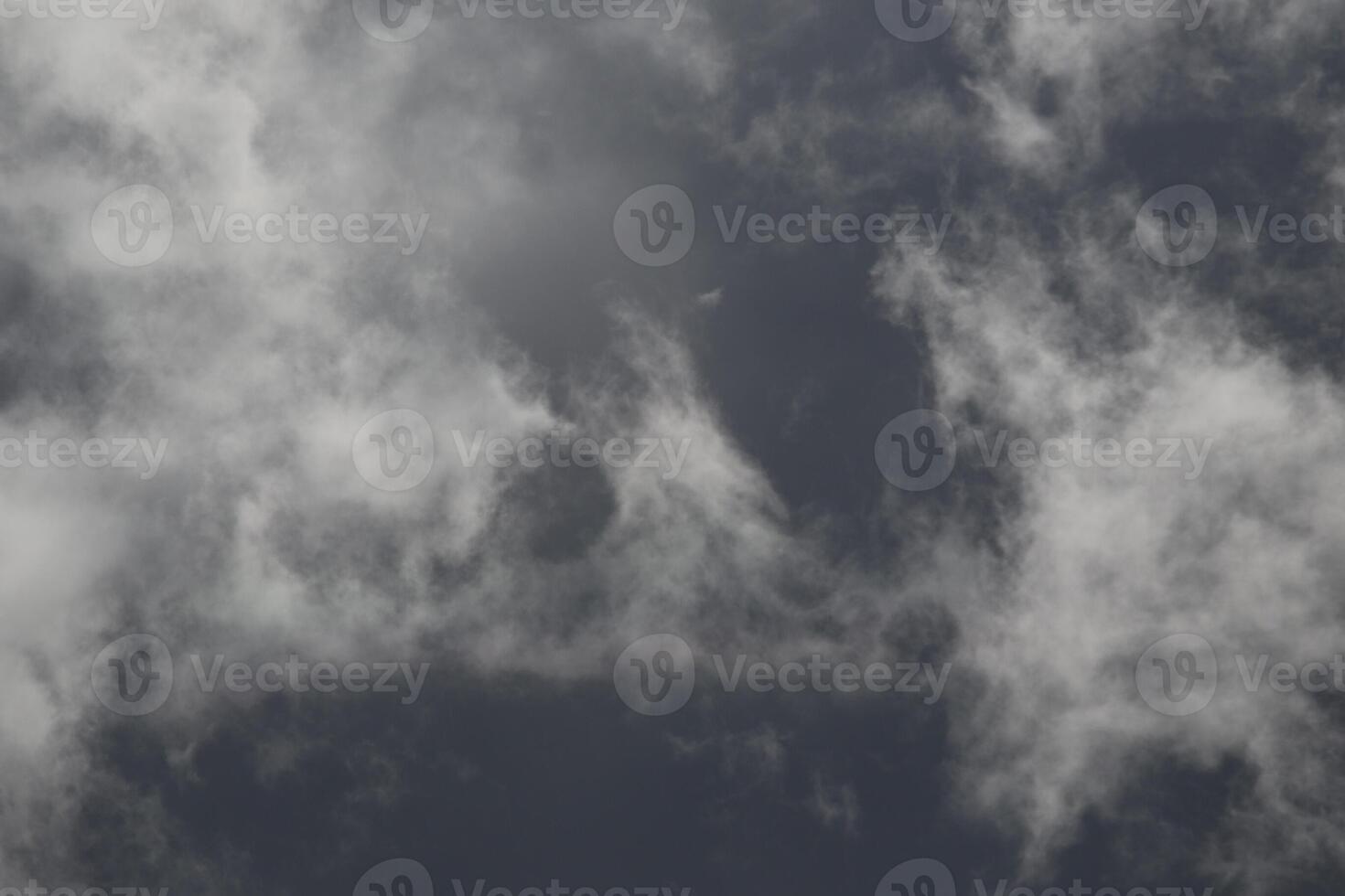 Cloudscape scenery, overcast weather above dark blue sky. Storm clouds floating in a rainy dull day with natural light. White and grey scenic environment background. Nature view. photo