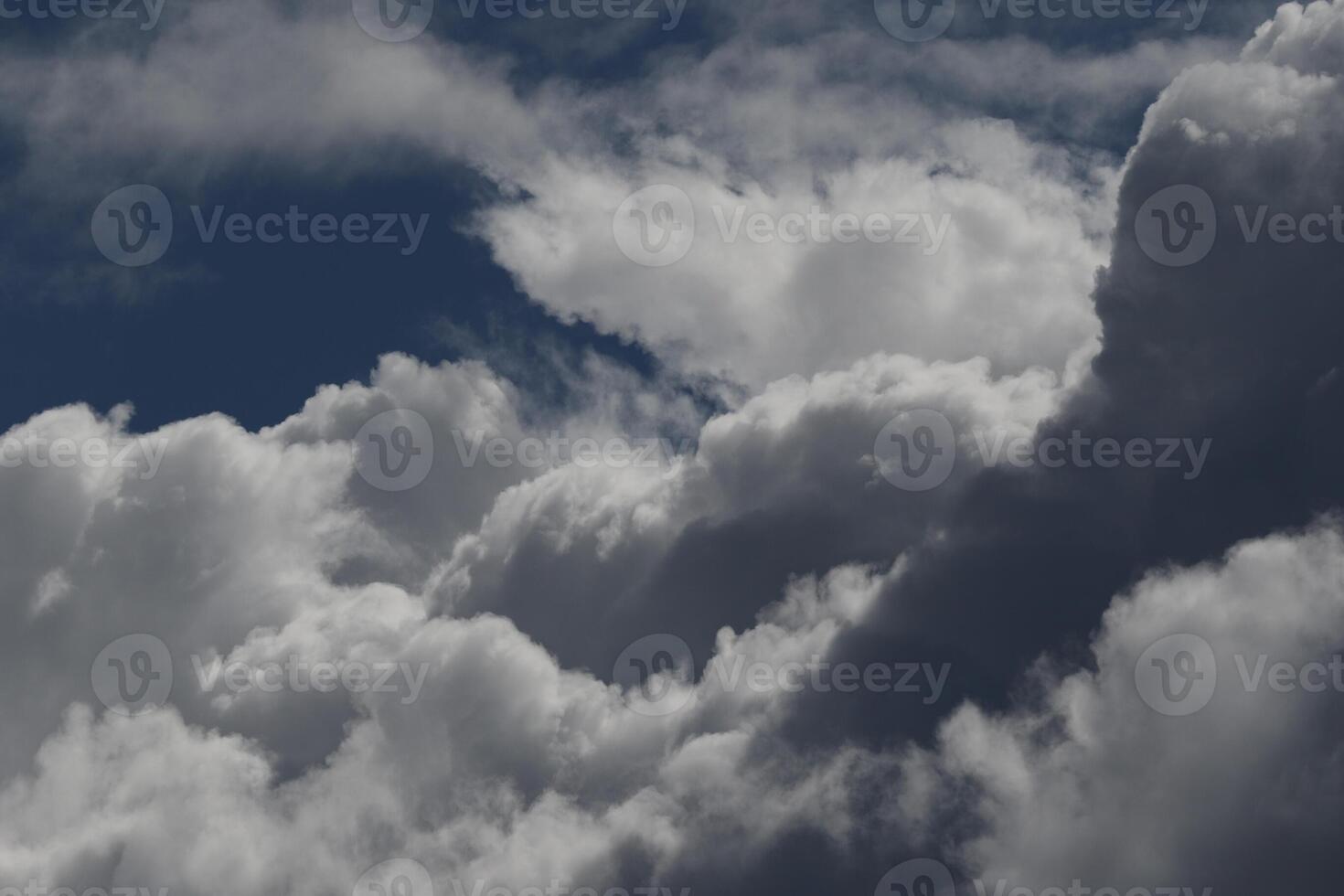 Cloudscape scenery, overcast weather above dark blue sky. Storm clouds floating in a rainy dull day with natural light. White and grey scenic environment background. Nature view. photo