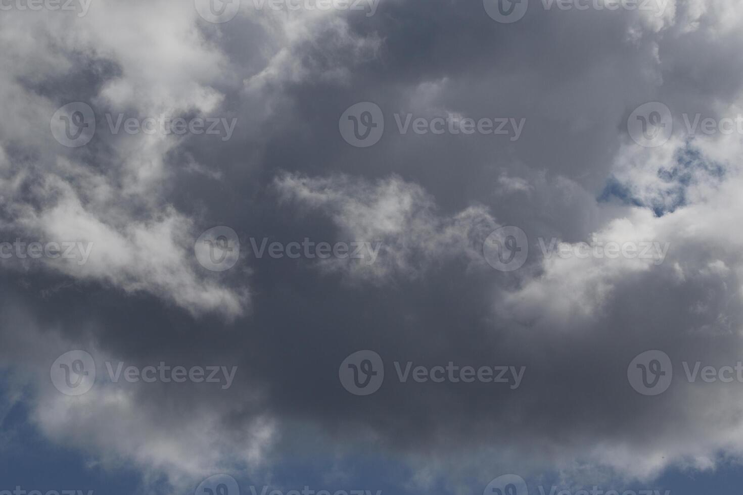 Cloudscape scenery, overcast weather above dark blue sky. Storm clouds floating in a rainy dull day with natural light. White and grey scenic environment background. Nature view. photo