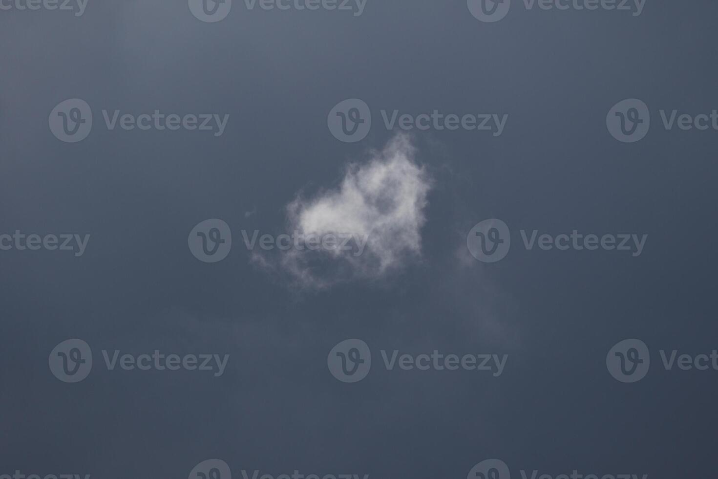 Cloudscape scenery, overcast weather above dark blue sky. Storm clouds floating in a rainy dull day with natural light. White and grey scenic environment background. Nature view. photo