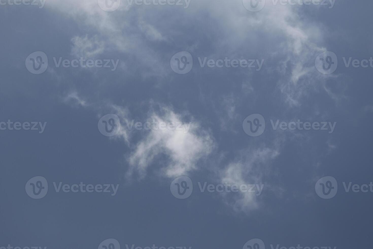 Cloudscape scenery, overcast weather above dark blue sky. Storm clouds floating in a rainy dull day with natural light. White and grey scenic environment background. Nature view. photo