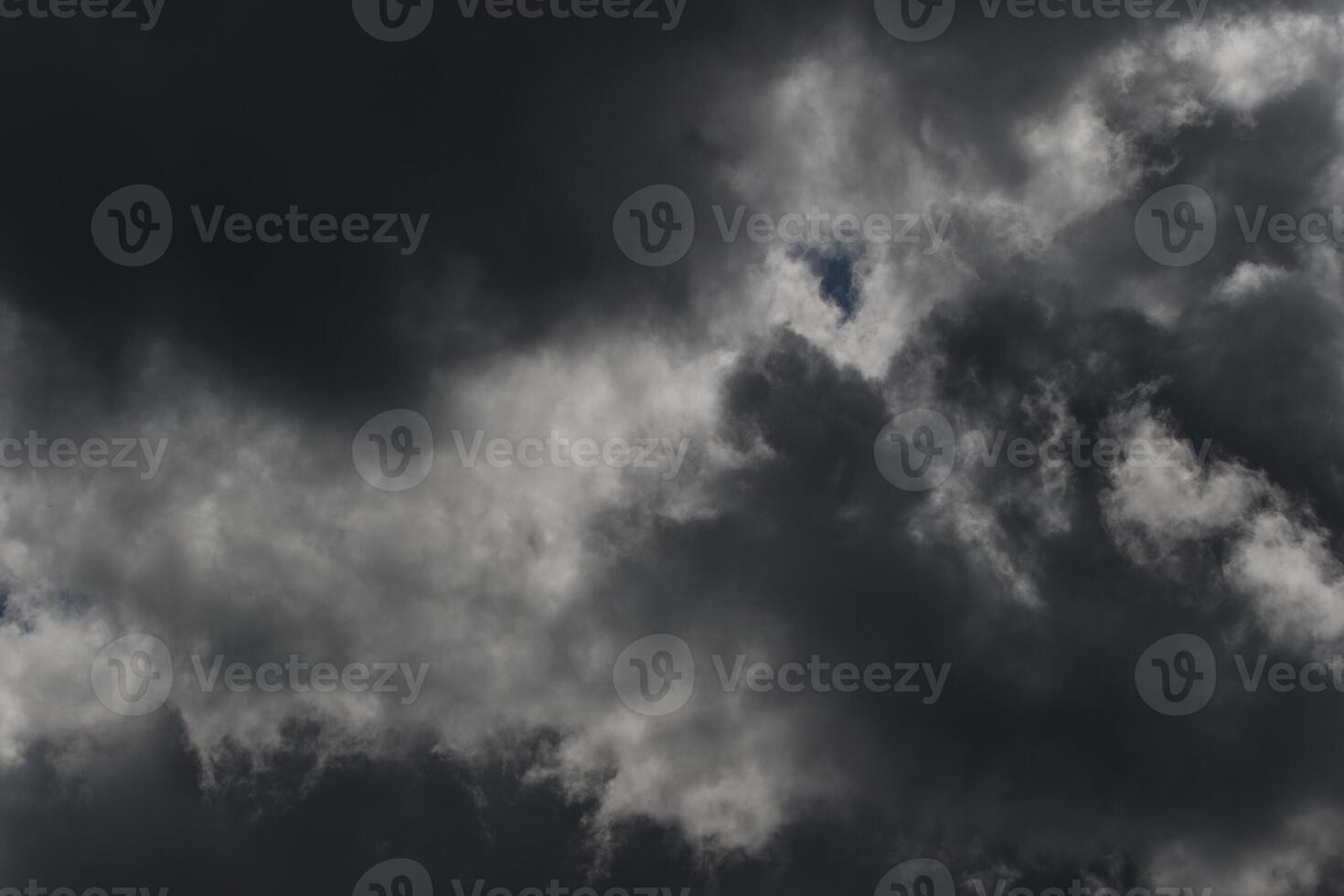 Cloudscape scenery, overcast weather above dark blue sky. Storm clouds floating in a rainy dull day with natural light. White and grey scenic environment background. Nature view. photo