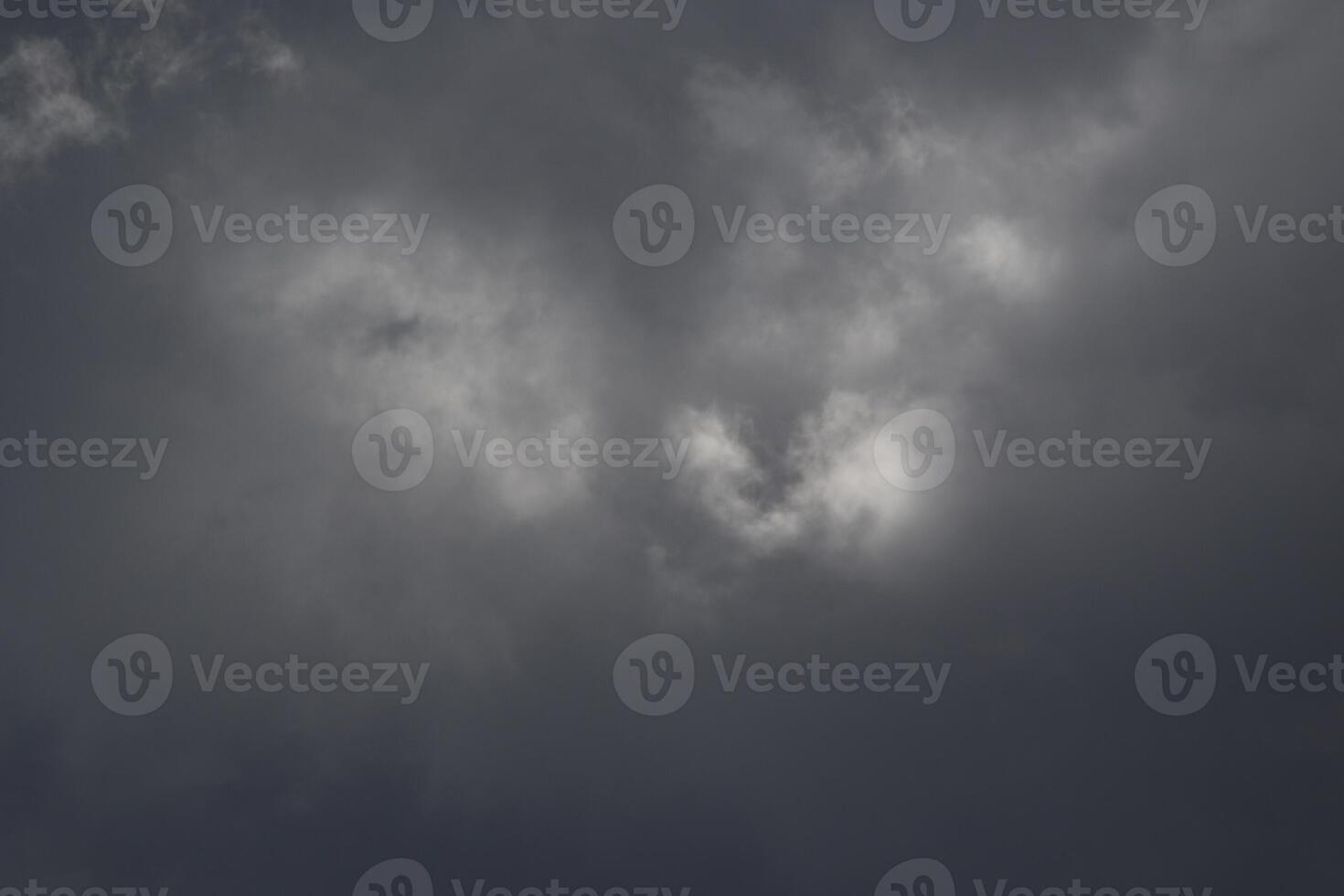 Cloudscape scenery, overcast weather above dark blue sky. Storm clouds floating in a rainy dull day with natural light. White and grey scenic environment background. Nature view. photo