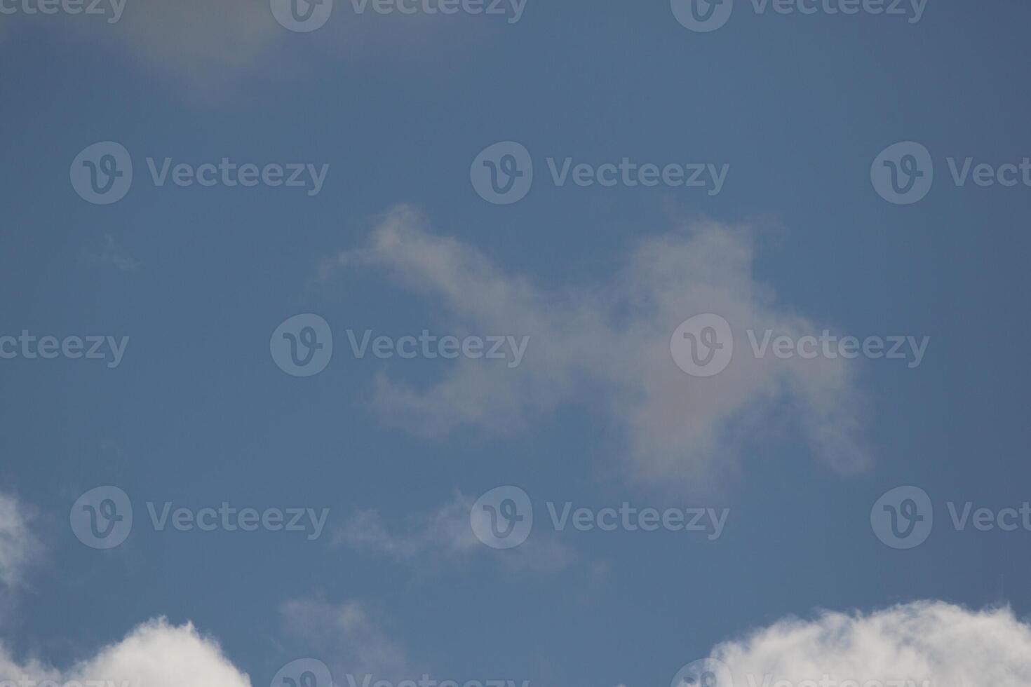 Cloudscape scenery, overcast weather above dark blue sky. Storm clouds floating in a rainy dull day with natural light. White and grey scenic environment background. Nature view. photo