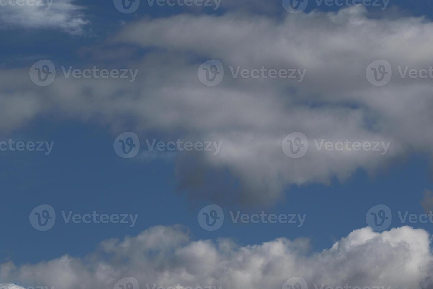 Cloudscape scenery, overcast weather above dark blue sky. Storm clouds floating in a rainy dull day with natural light. White and grey scenic environment background. Nature view. photo