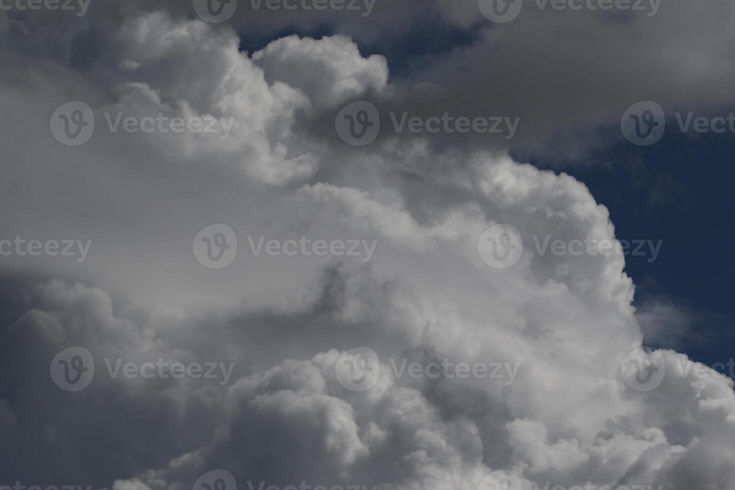 Cloudscape scenery, overcast weather above dark blue sky. Storm clouds floating in a rainy dull day with natural light. White and grey scenic environment background. Nature view. photo