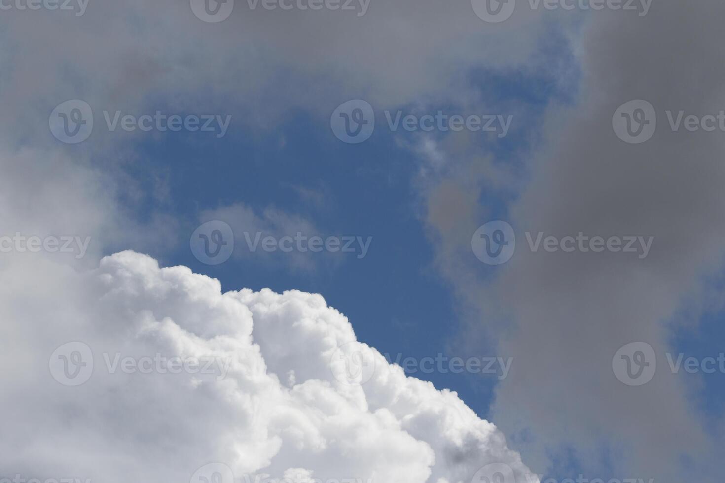 Cloudscape scenery, overcast weather above dark blue sky. Storm clouds floating in a rainy dull day with natural light. White and grey scenic environment background. Nature view. photo