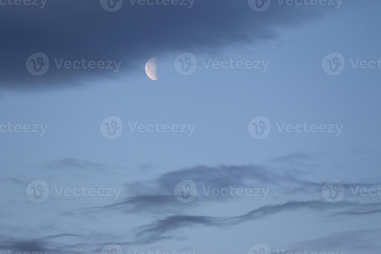 The colorful blue soft sky above the clouds with half moon photo