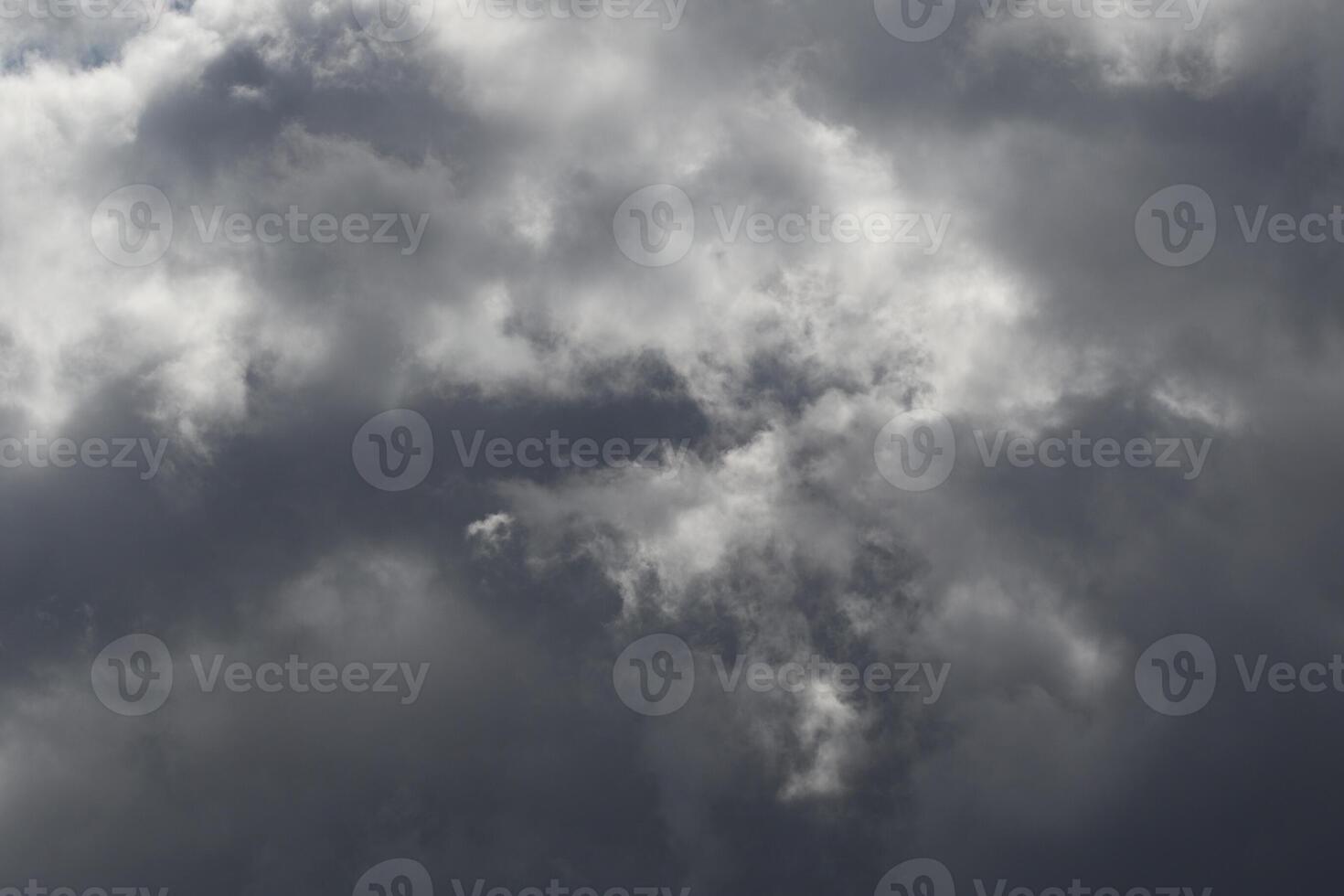 Cloudscape scenery, overcast weather above dark blue sky. Storm clouds floating in a rainy dull day with natural light. White and grey scenic environment background. Nature view. photo