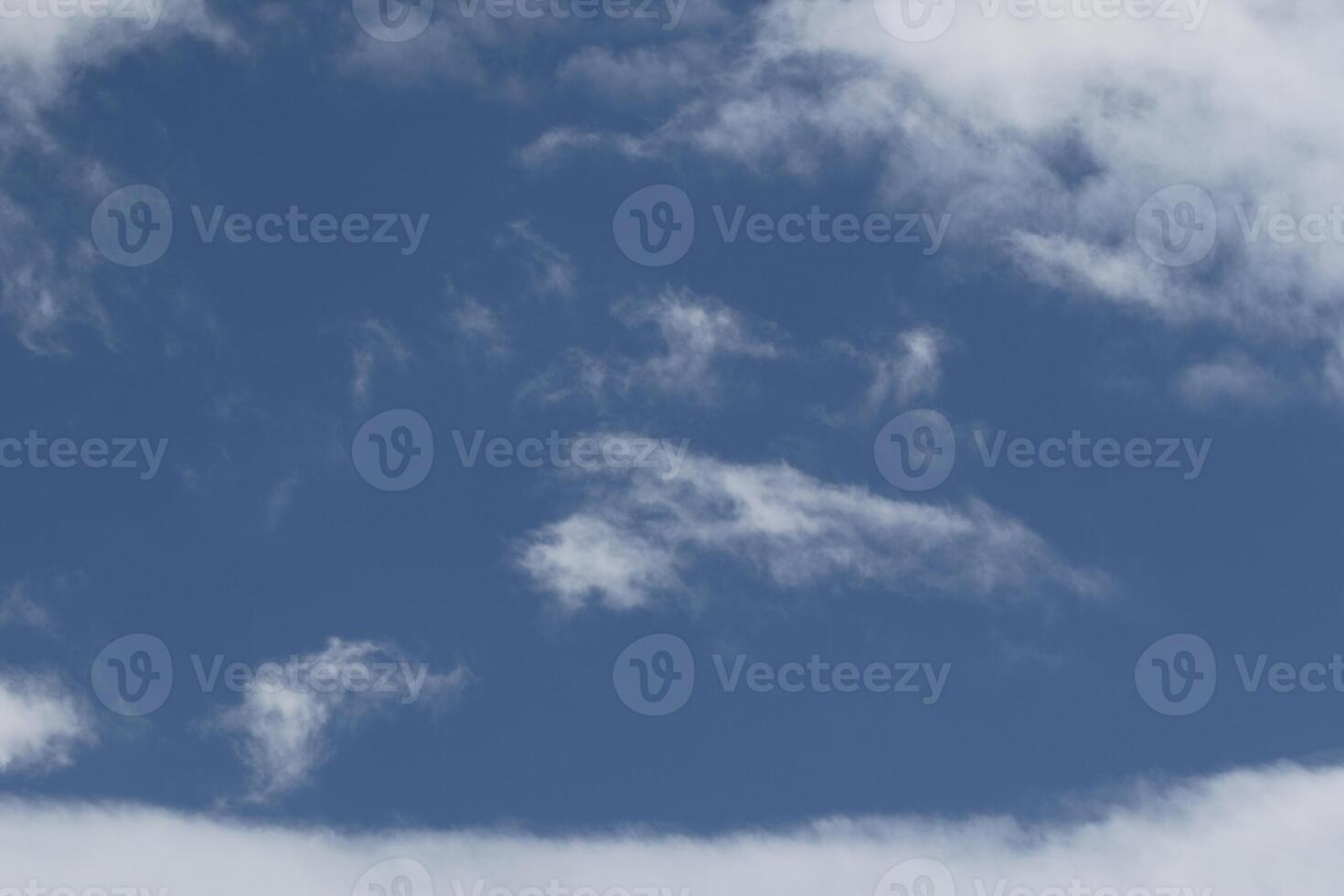 Cloudscape scenery, overcast weather above dark blue sky. Storm clouds floating in a rainy dull day with natural light. White and grey scenic environment background. Nature view. photo