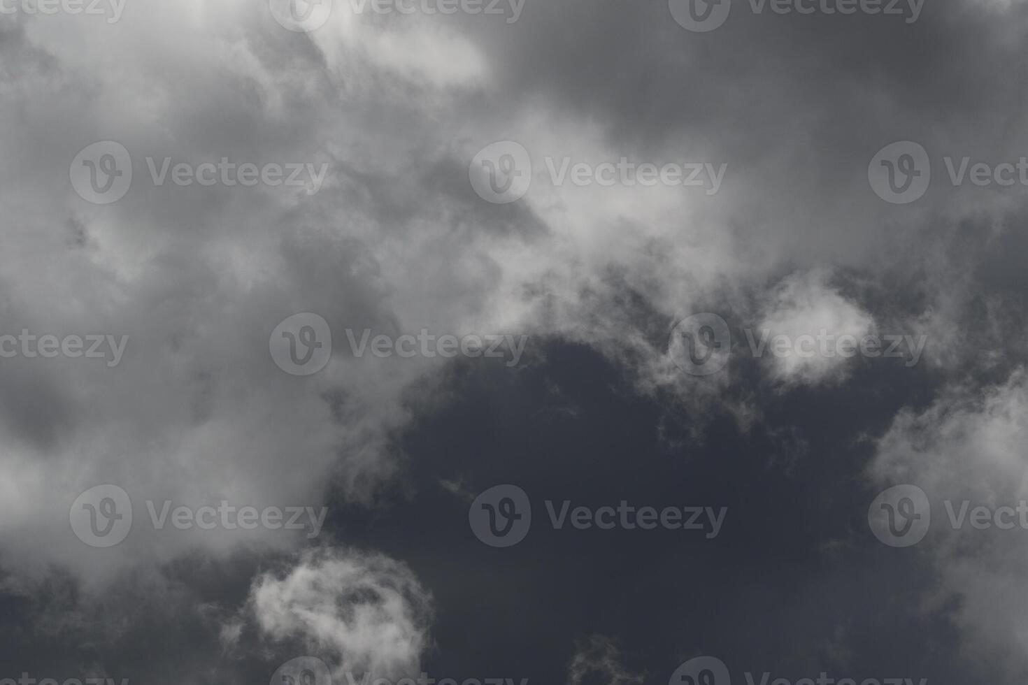 Cloudscape scenery, overcast weather above dark blue sky. Storm clouds floating in a rainy dull day with natural light. White and grey scenic environment background. Nature view. photo