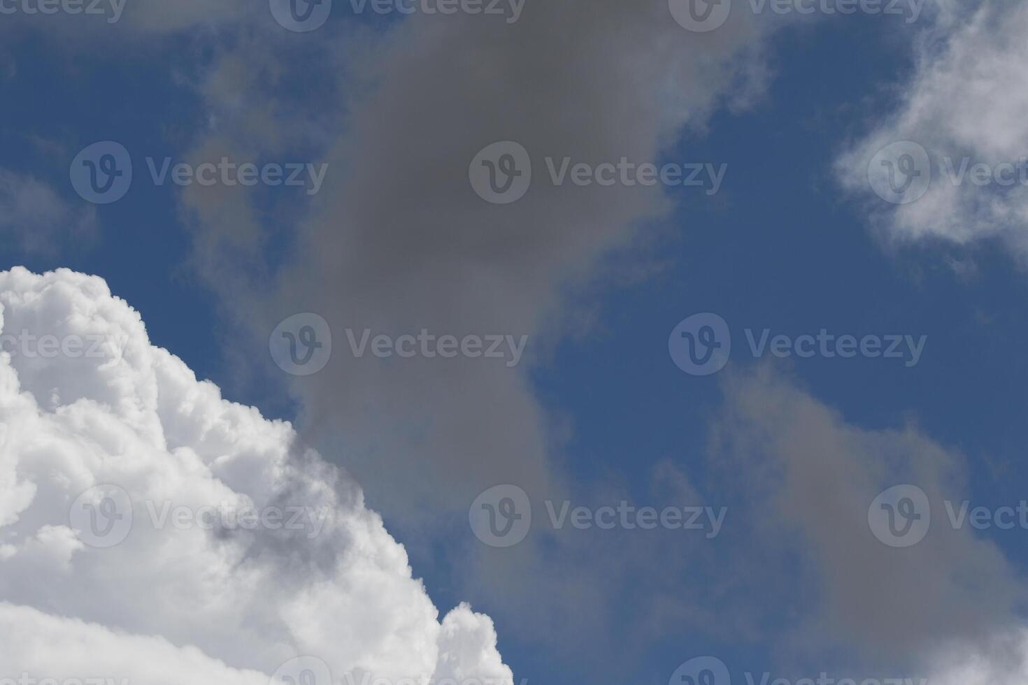 Cloudscape scenery, overcast weather above dark blue sky. Storm clouds floating in a rainy dull day with natural light. White and grey scenic environment background. Nature view. photo