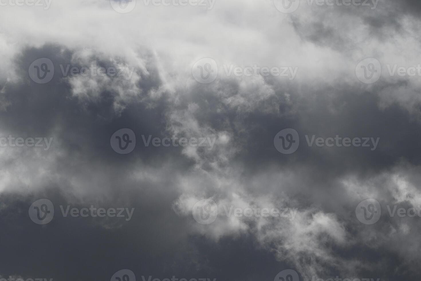 Cloudscape scenery, overcast weather above dark blue sky. Storm clouds floating in a rainy dull day with natural light. White and grey scenic environment background. Nature view. photo