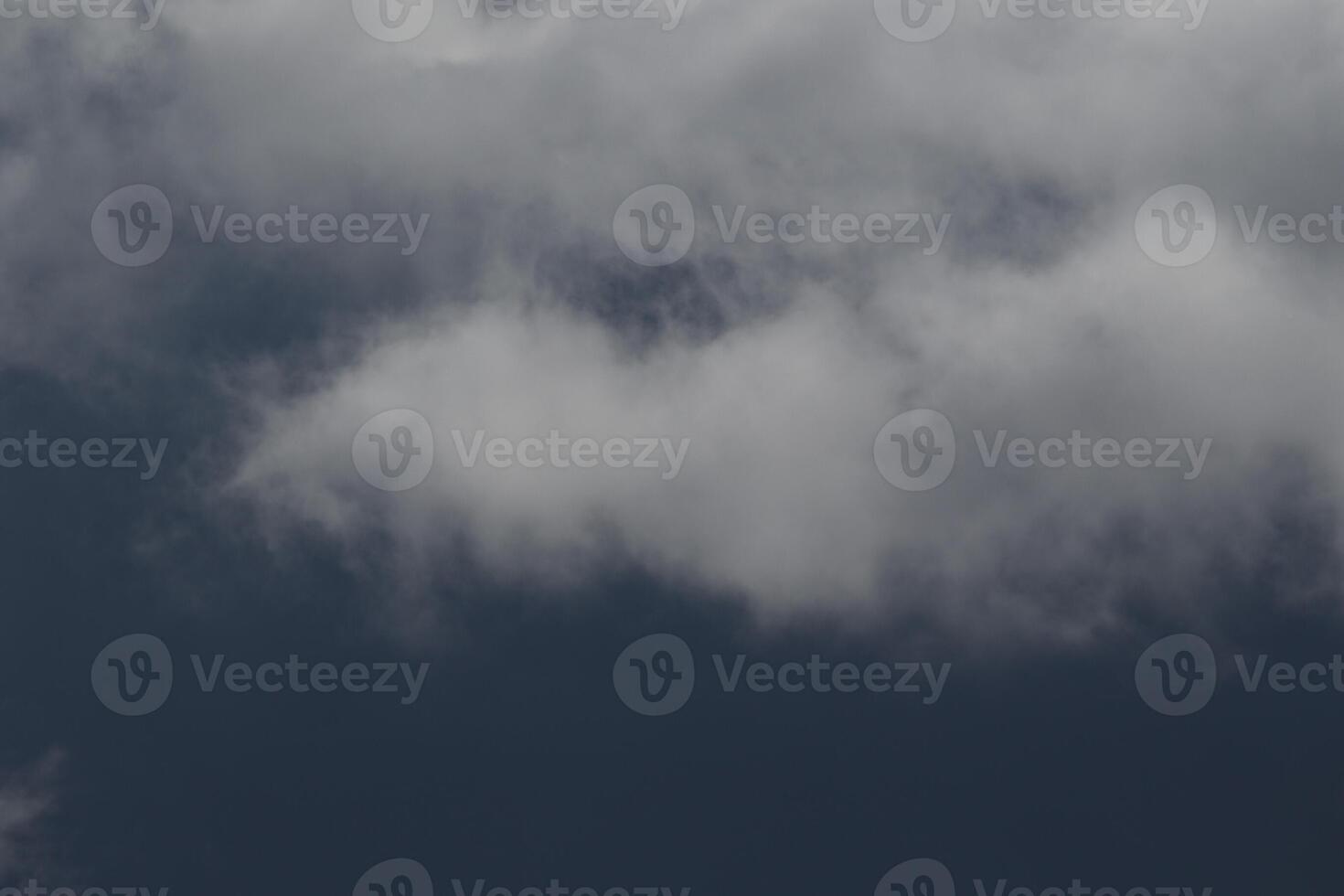 Cloudscape scenery, overcast weather above dark blue sky. Storm clouds floating in a rainy dull day with natural light. White and grey scenic environment background. Nature view. photo