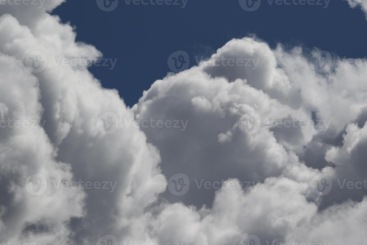 Cloudscape scenery, overcast weather above dark blue sky. Storm clouds floating in a rainy dull day with natural light. White and grey scenic environment background. Nature view. photo