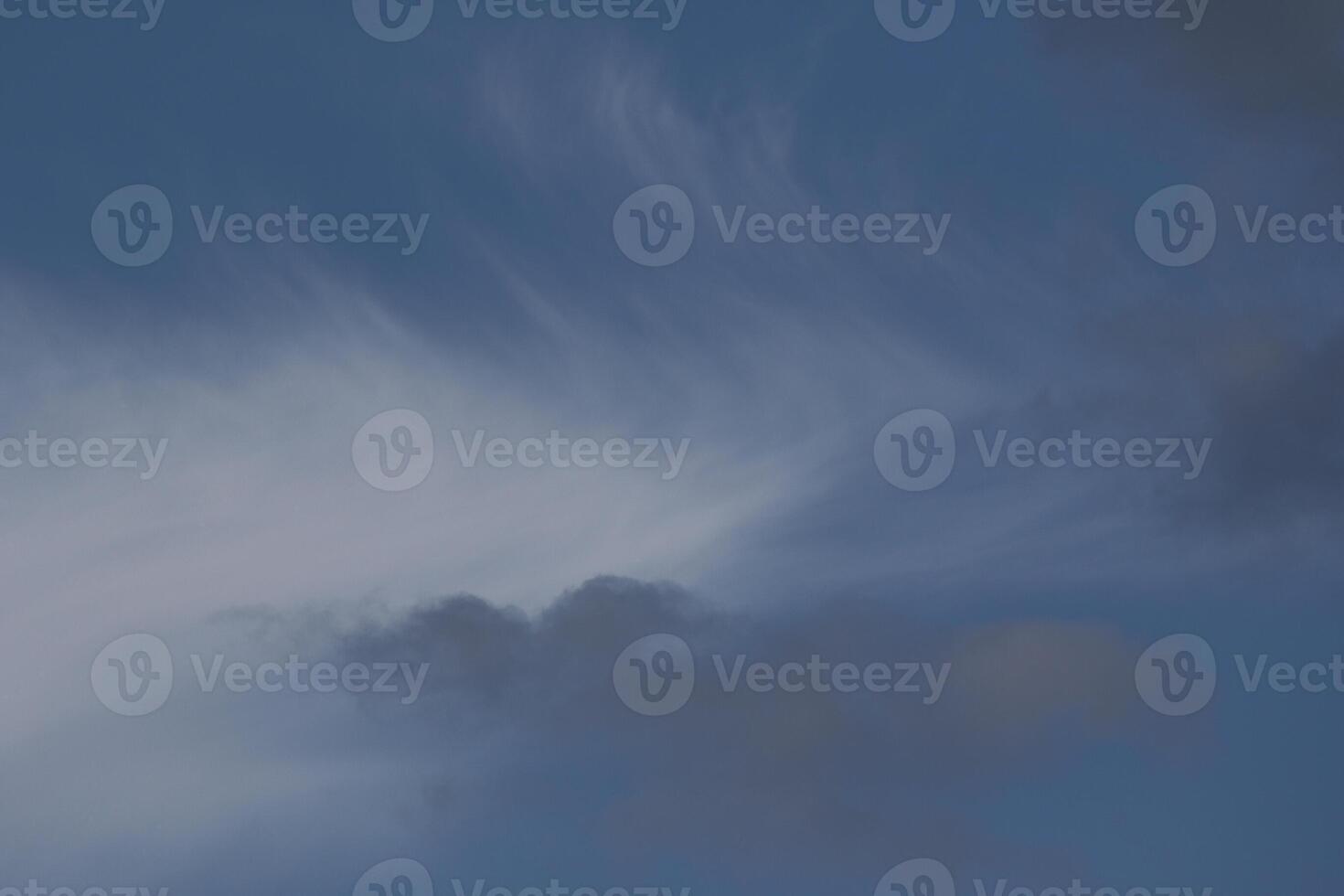 Cloudscape scenery, overcast weather above dark blue sky. Storm clouds floating in a rainy dull day with natural light. White and grey scenic environment background. Nature view. photo