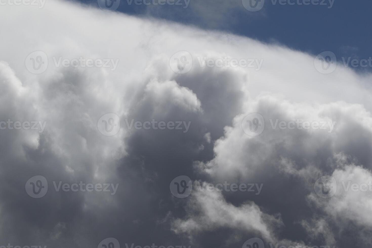 Cloudscape scenery, overcast weather above dark blue sky. Storm clouds floating in a rainy dull day with natural light. White and grey scenic environment background. Nature view. photo