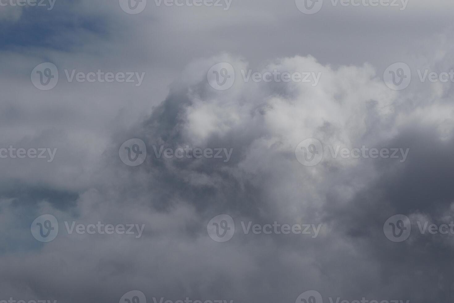 Cloudscape scenery, overcast weather above dark blue sky. Storm clouds floating in a rainy dull day with natural light. White and grey scenic environment background. Nature view. photo